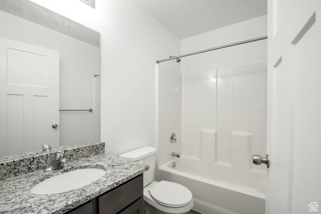 Full bathroom with vanity, toilet, and washtub / shower combination