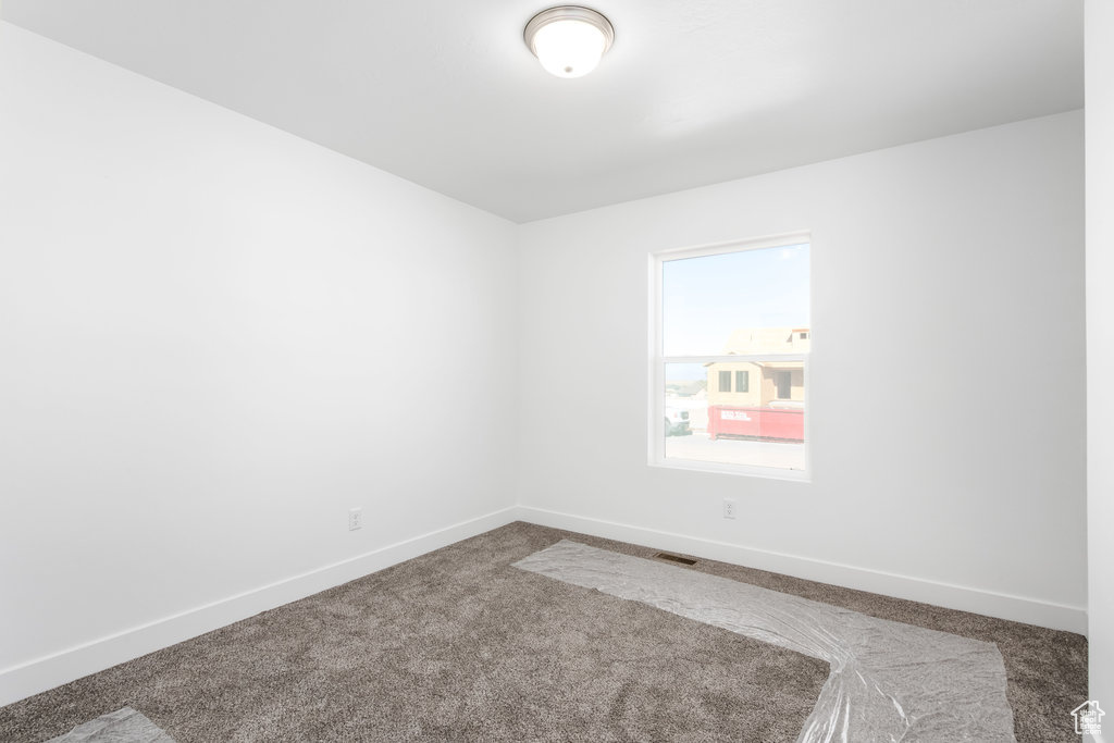 Unfurnished room featuring carpet flooring