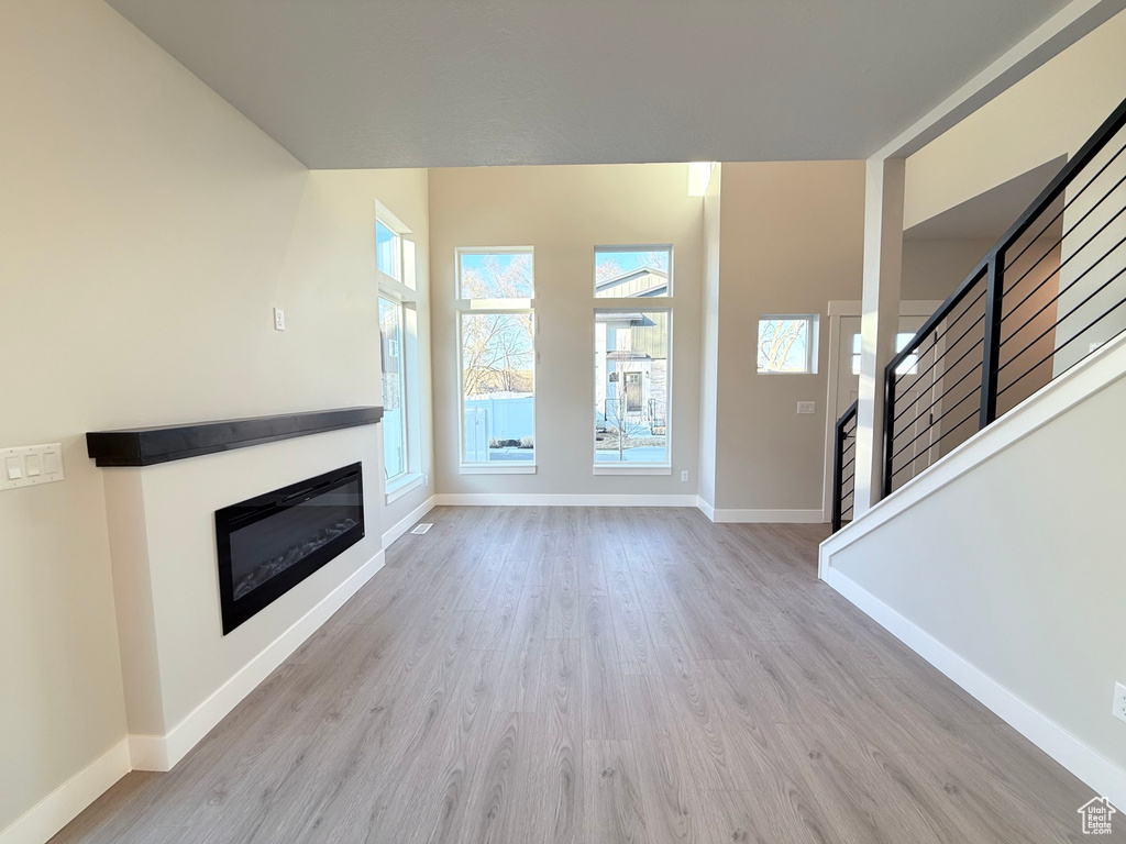 Unfurnished living room with light wood-type flooring