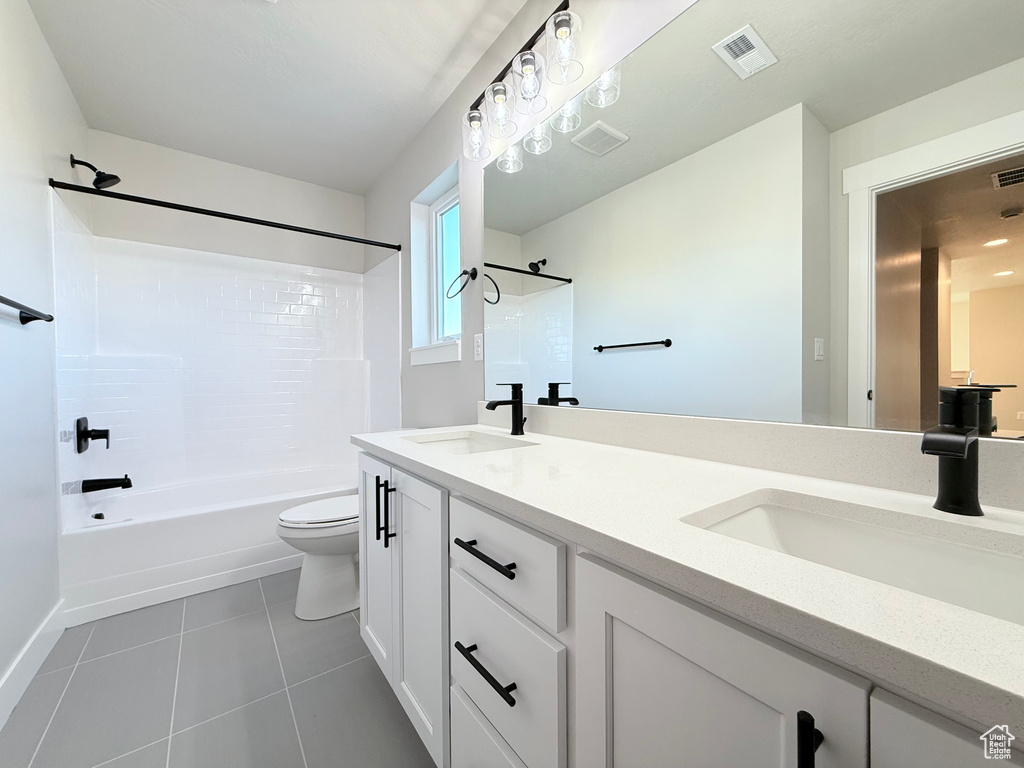 Full bathroom featuring toilet, bathtub / shower combination, vanity, and tile patterned floors