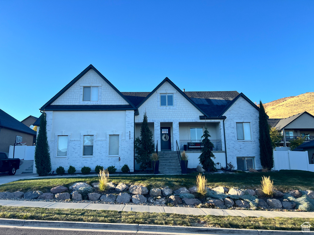 View of front facade featuring a porch and a front lawn