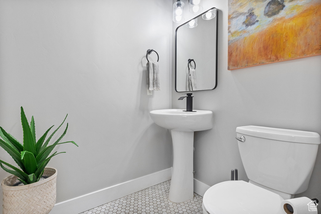 Bathroom featuring tile patterned flooring and toilet