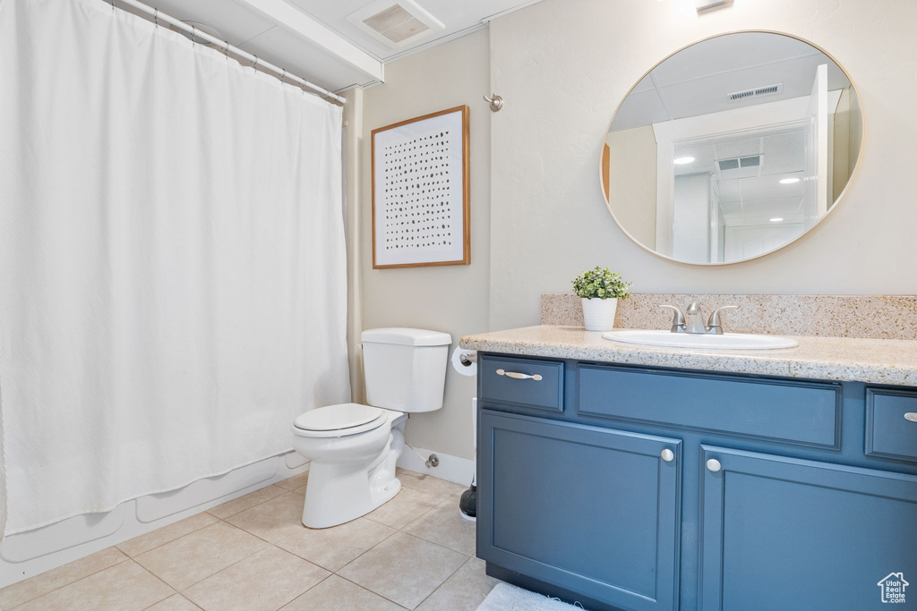 Full bathroom featuring tile patterned flooring, vanity, shower / tub combo, and toilet