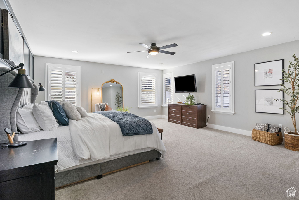 Bedroom with light colored carpet and ceiling fan