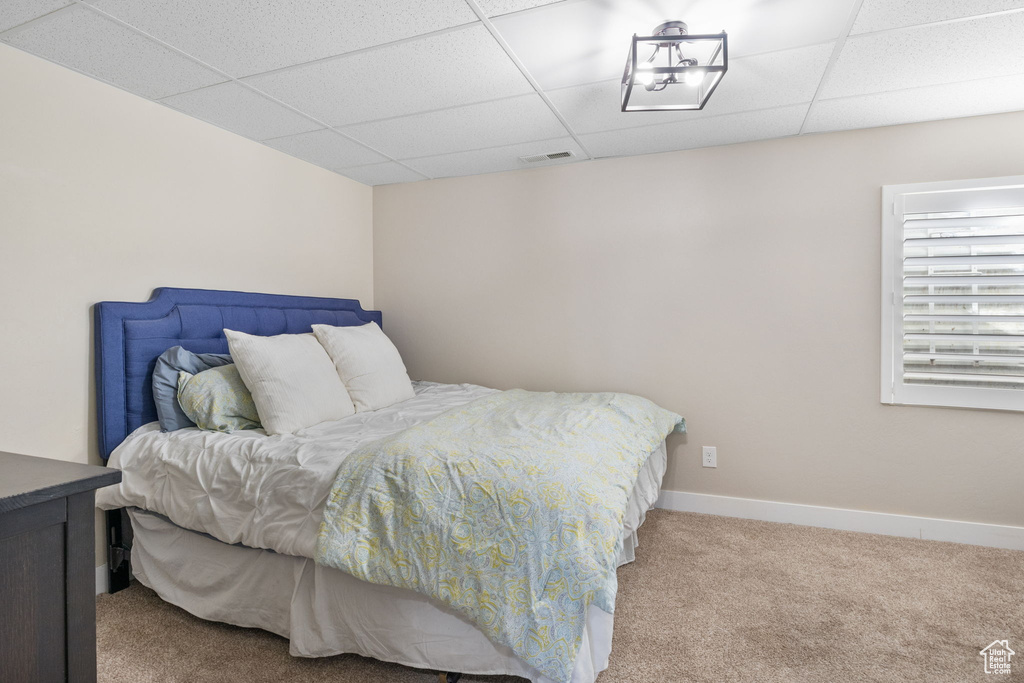 Carpeted bedroom featuring a paneled ceiling