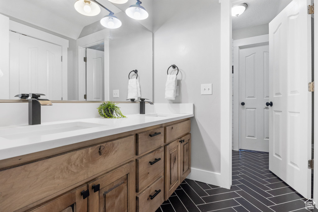 Bathroom featuring tile patterned flooring and vanity