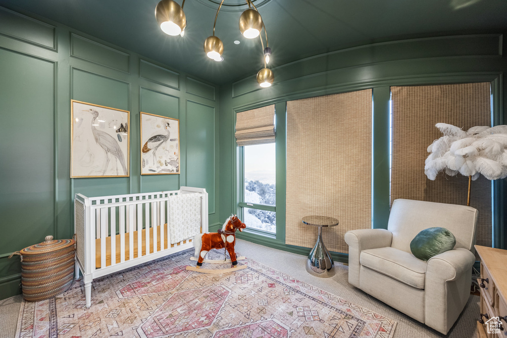 Bedroom with light carpet and a nursery area