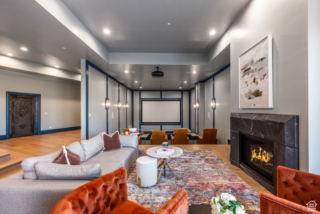 Home theater room featuring a premium fireplace and wood-type flooring