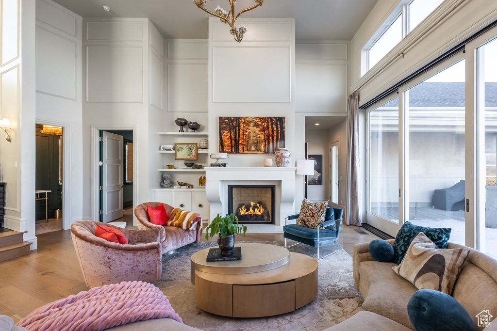 Living room featuring light hardwood / wood-style floors and a towering ceiling