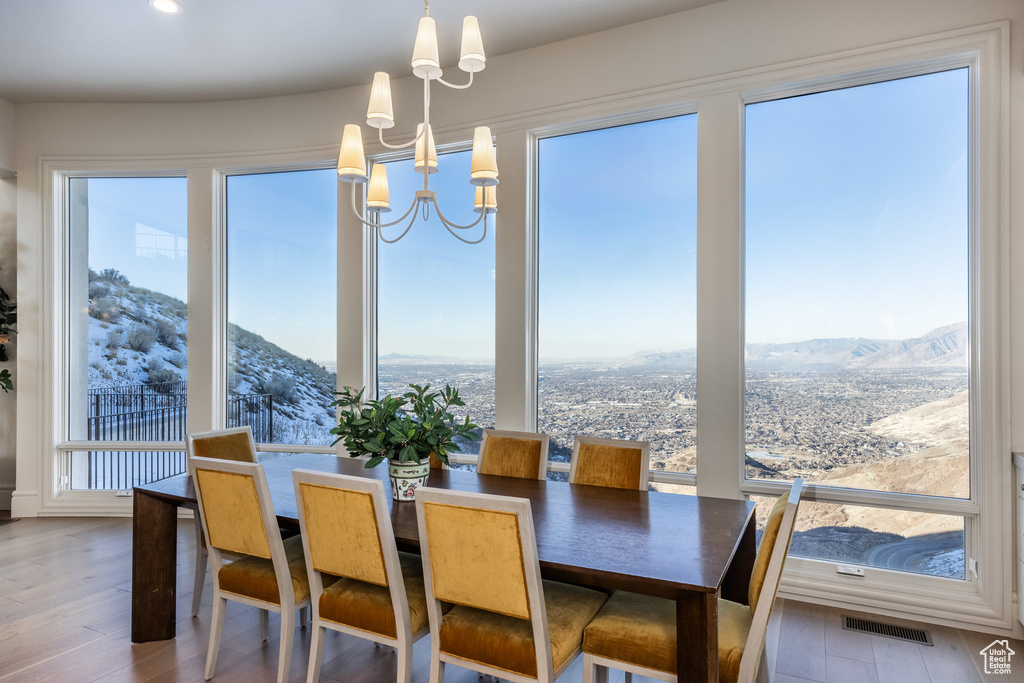 Dining room featuring a mountain view, hardwood / wood-style flooring, and a chandelier