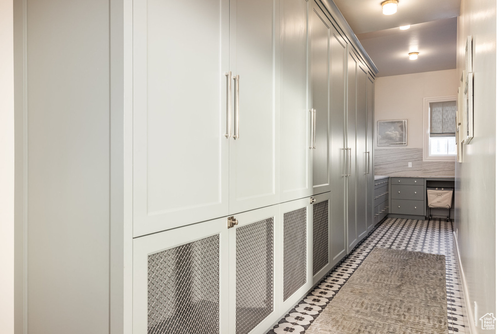 Hallway with tile patterned flooring