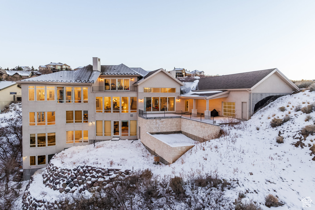View of snow covered back of property