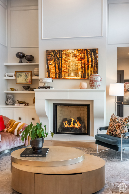 Living room featuring a warm lit fireplace