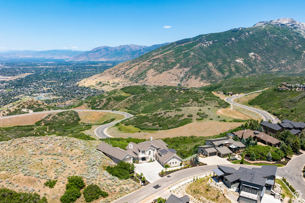 Aerial view of property's location featuring a mountainous background
