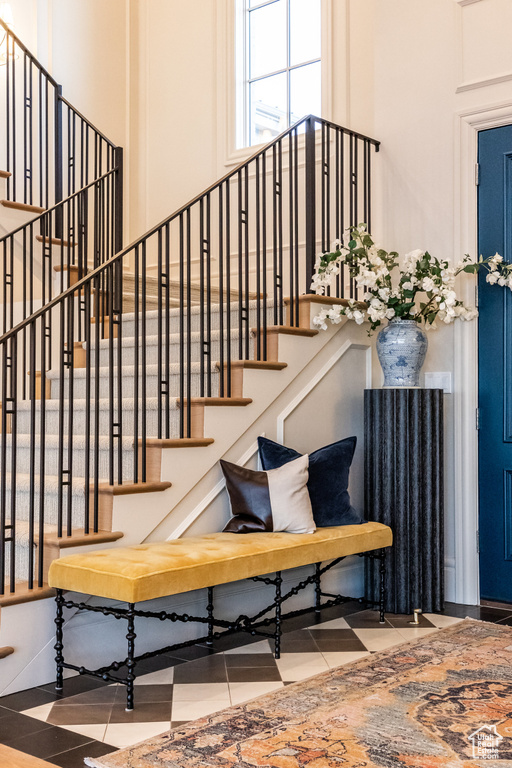 Staircase with a towering ceiling