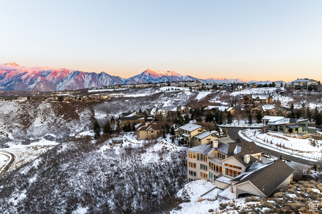 Snowy aerial view featuring a residential view and a mountain view