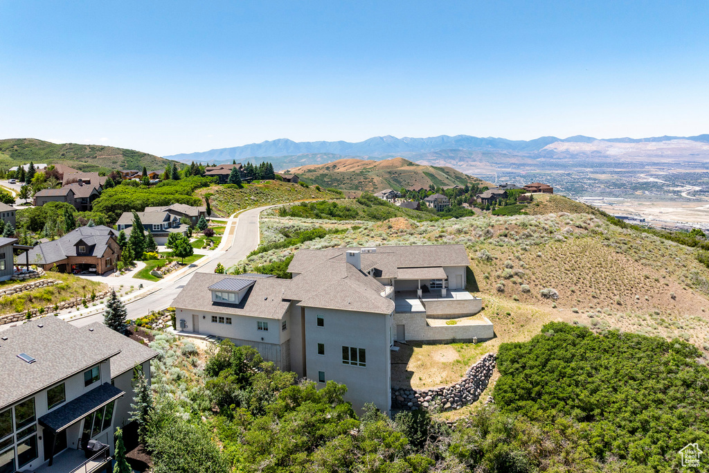 Aerial view of residential area featuring a mountainous background