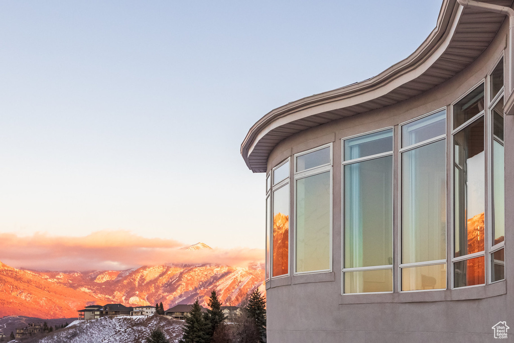 Property exterior at dusk featuring a mountain view