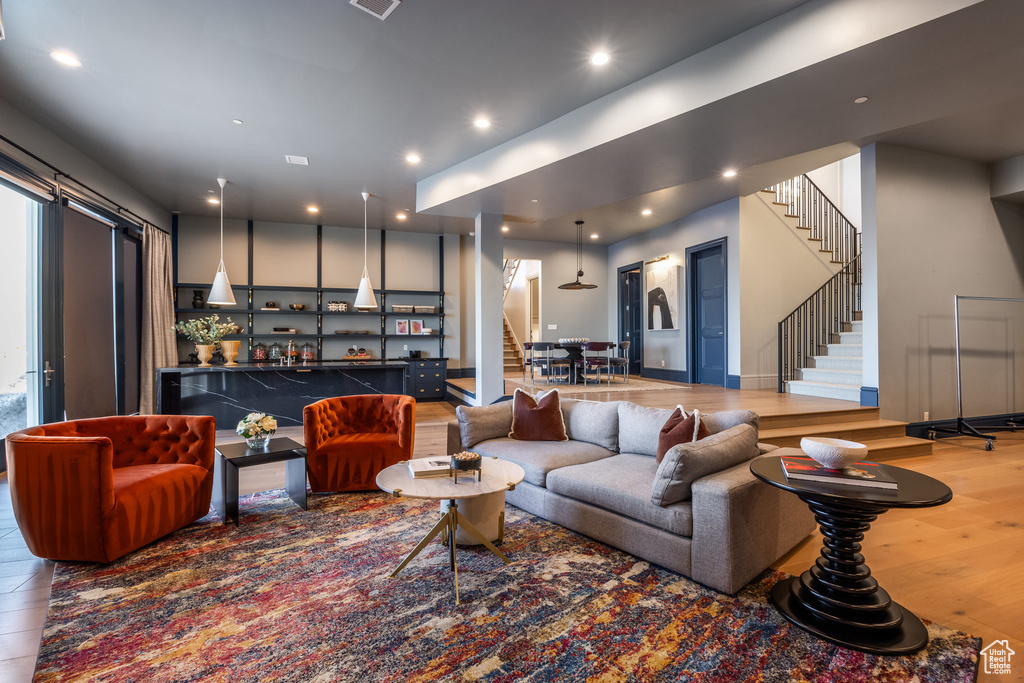 Living room featuring bar and wood-type flooring