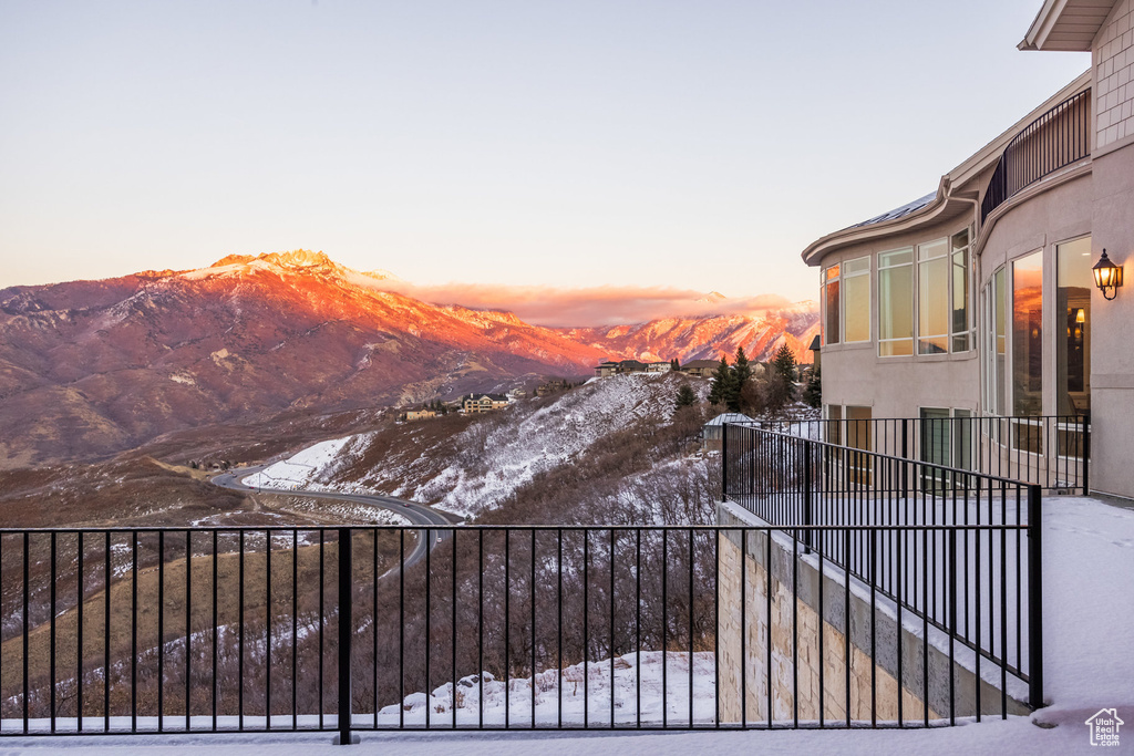 Snow covered gate featuring a mountain view