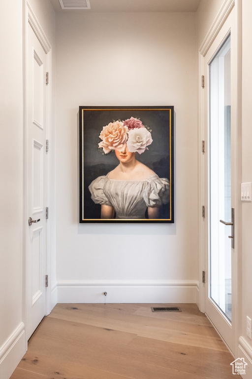 Hallway featuring wood finished floors and baseboards