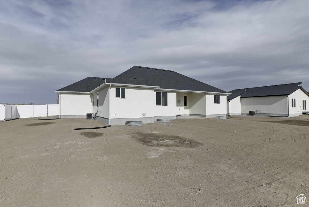 Rear view of house with central AC unit