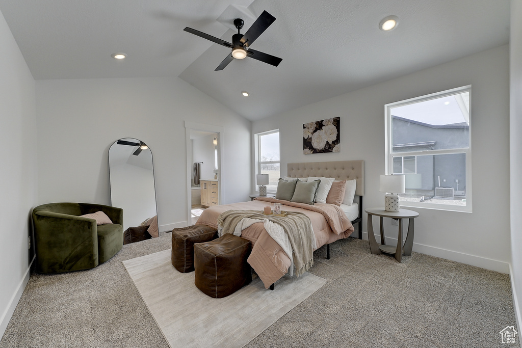 Carpeted bedroom featuring ceiling fan, lofted ceiling, and connected bathroom