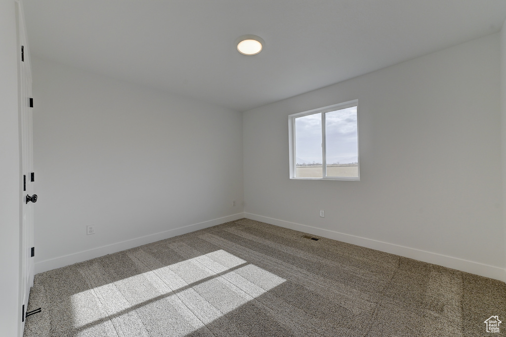 Unfurnished room with carpet floors