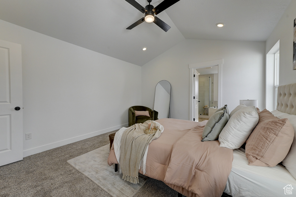 Bedroom featuring carpet floors, ensuite bathroom, ceiling fan, and vaulted ceiling