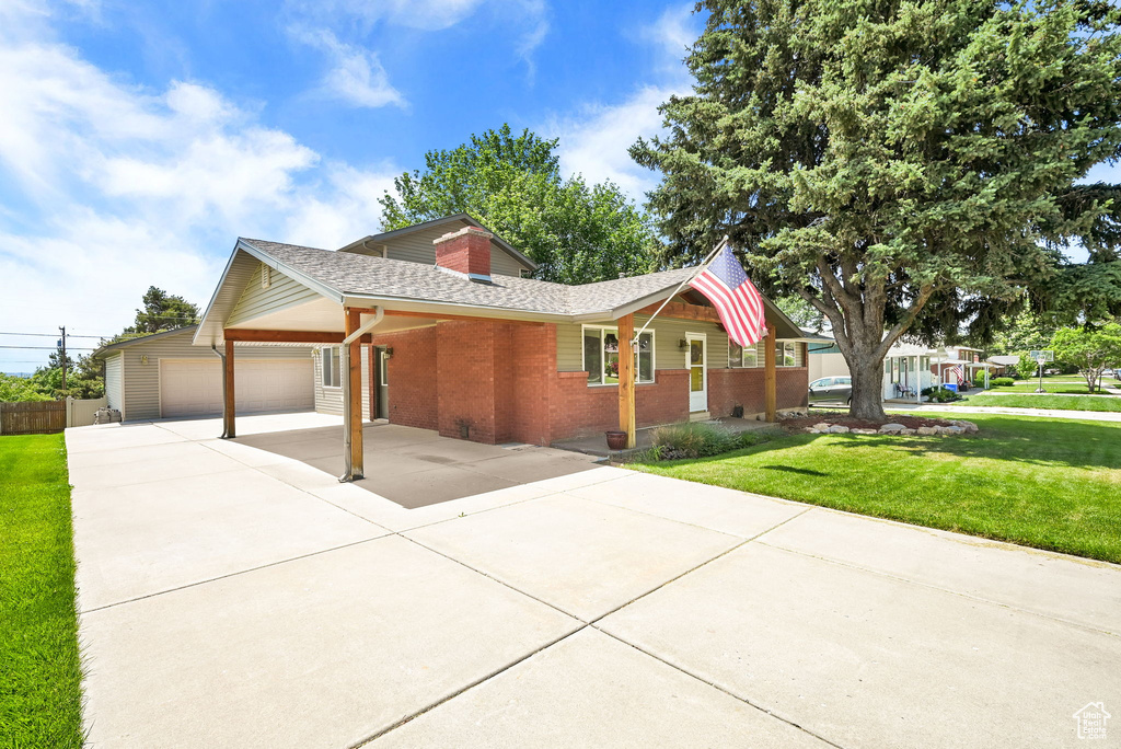Single story home with brick siding, driveway, and roof with shingles