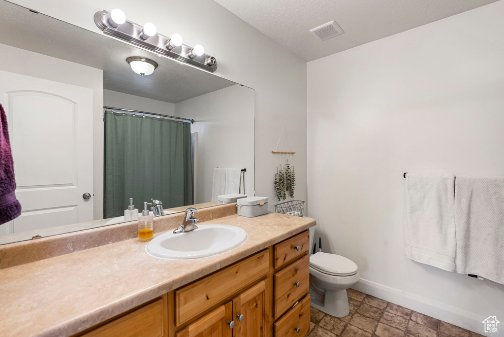 Bathroom with vanity and toilet