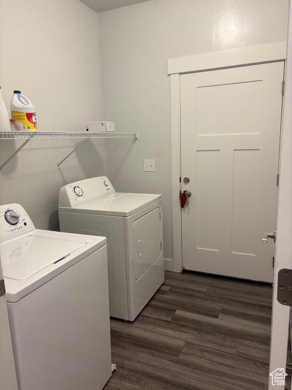Washroom featuring dark hardwood / wood-style floors and washer and clothes dryer