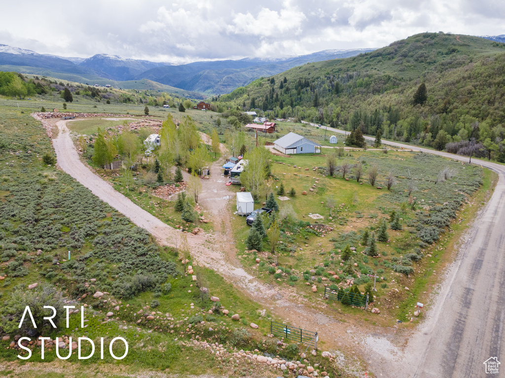 Aerial overview of property's location with a mountain backdrop and rural landscape