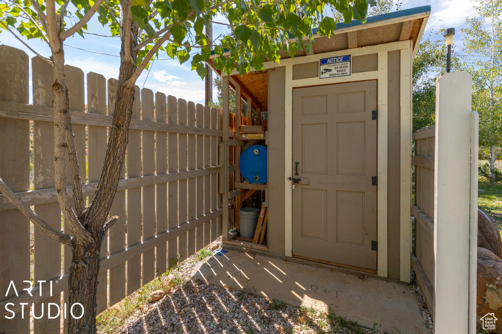 View of outbuilding featuring fence and an outbuilding