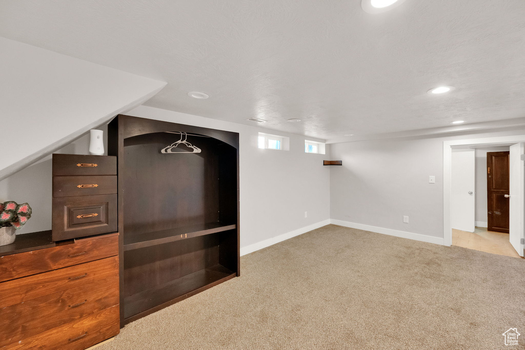 Below grade area featuring carpet floors and recessed lighting