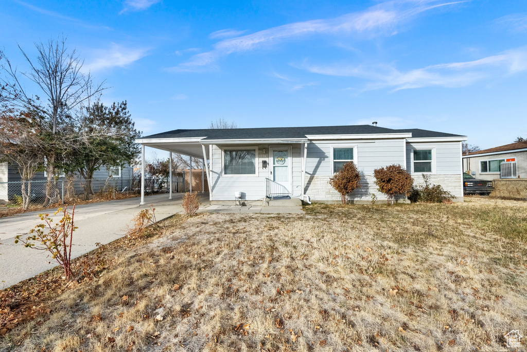 Ranch-style home featuring a carport