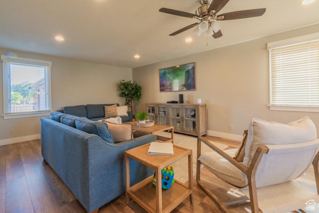 Living room with hardwood / wood-style floors and ceiling fan