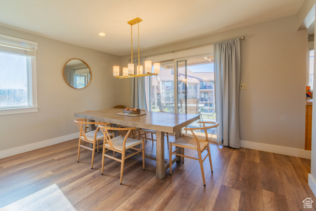 Dining area with a chandelier, hardwood / wood-style floors, and a wealth of natural light