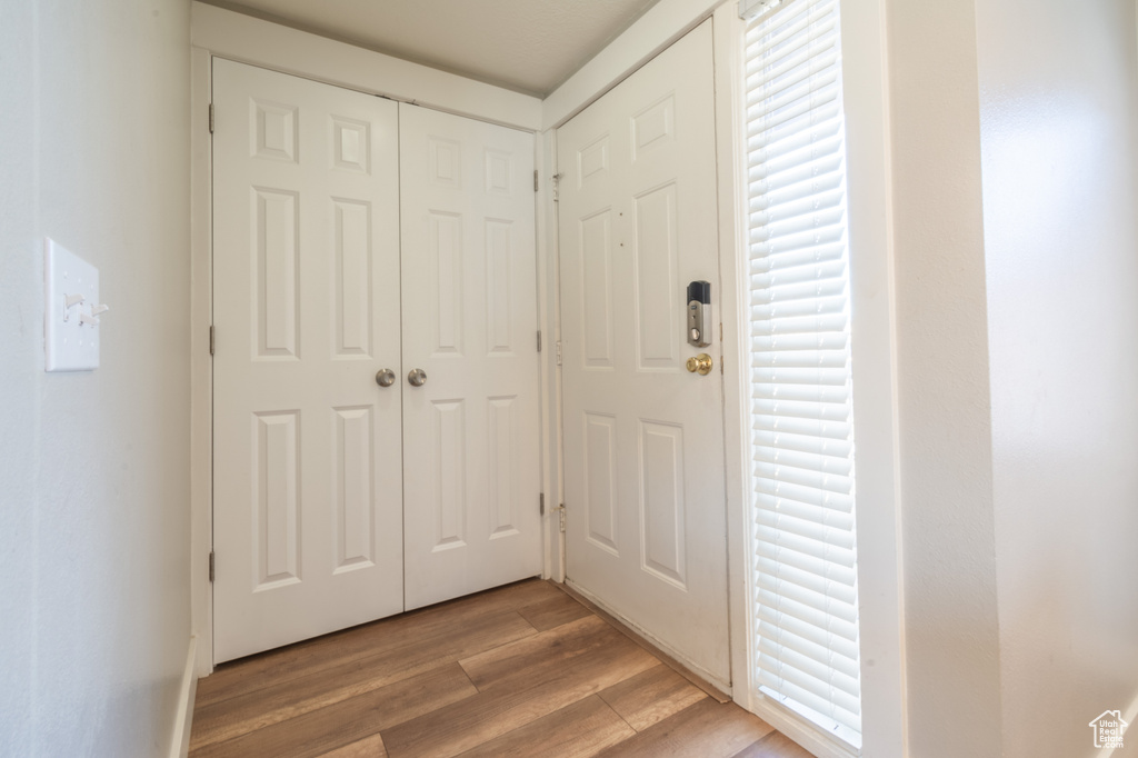 Doorway to outside with light wood-type flooring