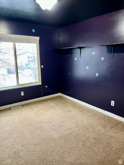 Unfurnished room featuring carpet floors