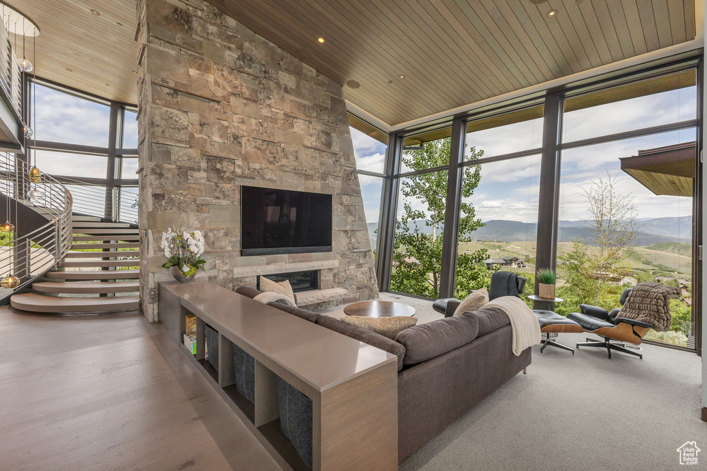 Living room featuring wooden ceiling and expansive windows
