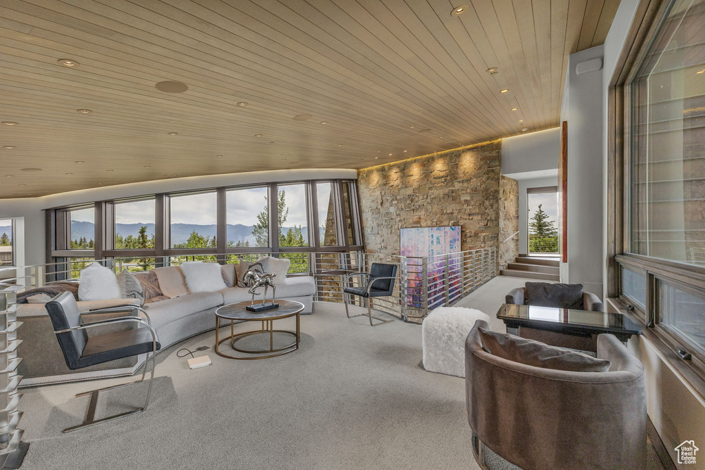 Living room featuring wood ceiling, carpet floors, recessed lighting, and a mountain view