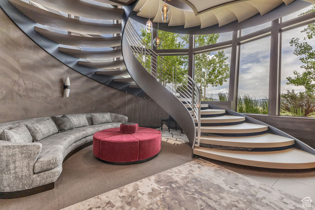 Living area with plenty of natural light and stairway