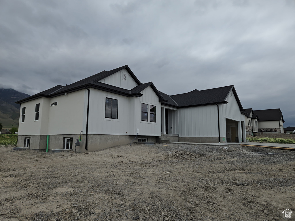 View of front of house featuring an attached garage and board and batten siding