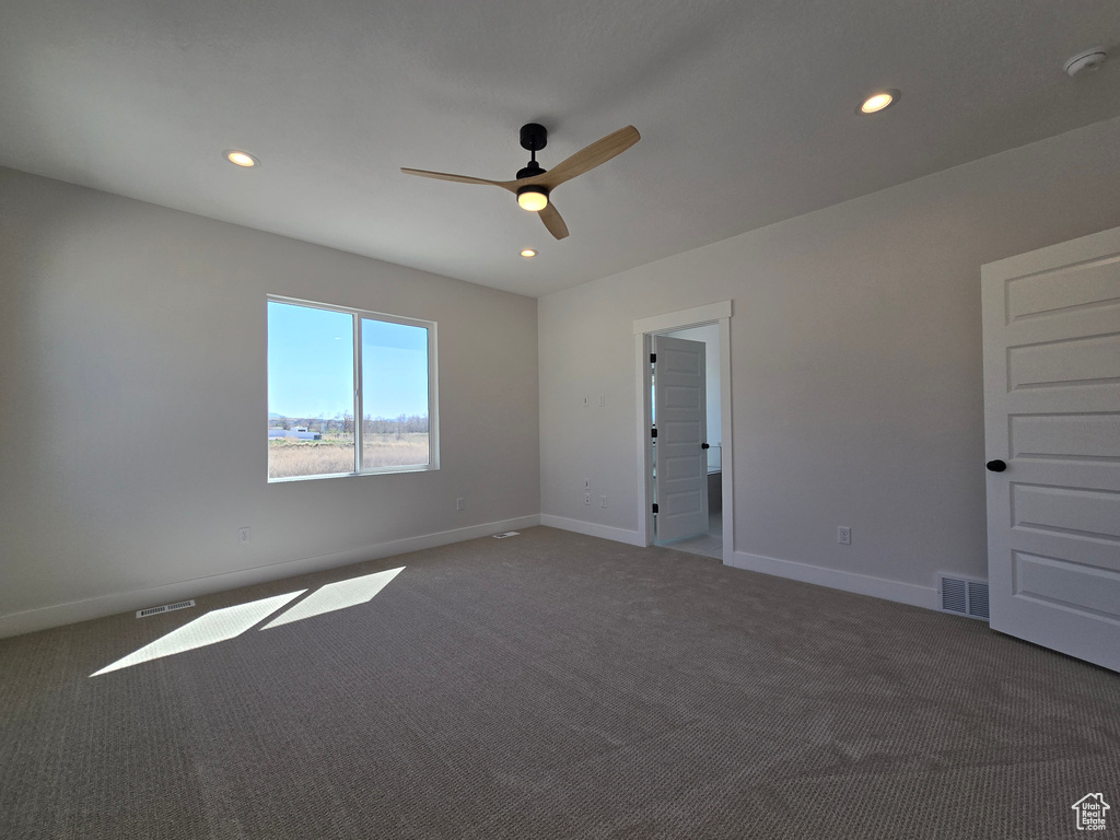 Empty room with a ceiling fan, recessed lighting, carpet flooring, and visible vents