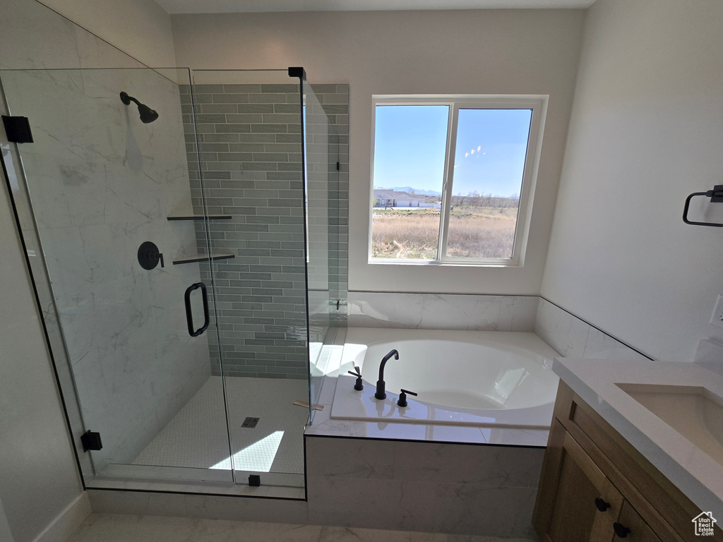 Bathroom featuring a stall shower, vanity, and a bath