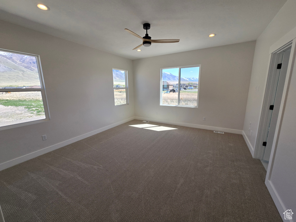 Unfurnished bedroom featuring dark colored carpet, baseboards, a ceiling fan, and recessed lighting