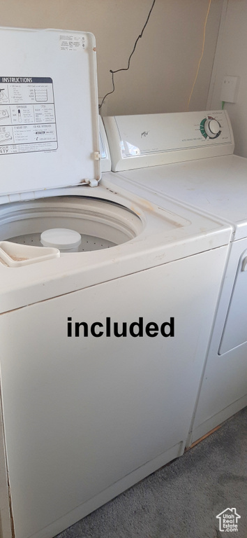 Clothes washing area with carpet and separate washer and dryer