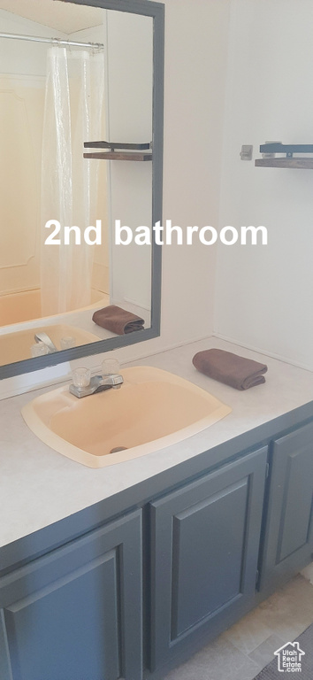 Bathroom with tile patterned floors and vanity