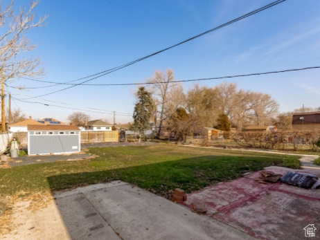 View of yard featuring a patio and an outdoor structure